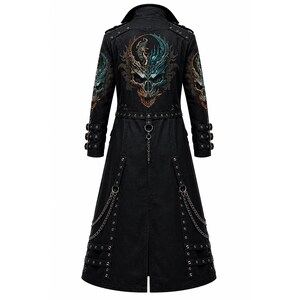 May include: A black long coat featuring a large, detailed graphic of a skull with dragon-like elements on the back. The coat includes metal eyelets, multiple buckled straps on the sleeves and lower hem, and decorative silver-toned chains attached to rings.