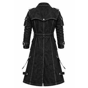 May include: A long black denim trench coat featuring a collared neckline, shoulder epaulets, and long sleeves with buckled cuffs. The coat includes a belted waist, two flap pockets on the upper sleeves, and decorative side straps with metal rings.