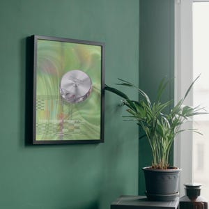 May include: A framed artwork featuring a silver, circular object with the text "Degrad" on a green and yellow background. The artwork is mounted on a dark green wall. The text "PEARL MEMORY SYSTEM VOL01" is at the bottom of the artwork.