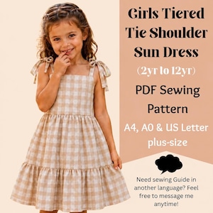 Könnte beinhalten: Ein beiges und weißes, gestuftes Sommerkleid mit kariertem Muster und Bindeträgern. Der Text lautet: Girls Tiered Tie Shoulder Sun Dress (2yr to 12yr) PDF Sewing Pattern A4, A0 & US Letter plus-size. Need sewing Guide in another language? Feel free to message me anytime!