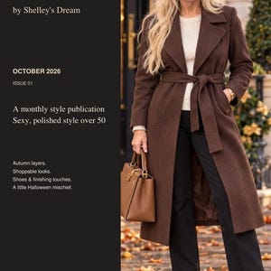 May include: A dark brown belted wool coat worn over a cream sweater and black trousers, paired with brown leather ankle boots and a matching brown handbag. The text reads: THE LOOKBOOK by Shelley's Dream, OCTOBER 2026, ISSUE 01, A monthly style publication, Sexy, polished style over 50, Autumn layers, Shoppable looks, Shoes & finishing touches, A little Halloween mischief, By Michelle Williams, AI-assisted styling portrait.