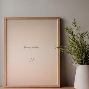 Könnte beinhalten: Ein gerahmter Druck mit hellbraunem Hintergrund und den Worten "Heute reicht." sowie einem Herzsymbol. Der Rahmen ist aus hellem Holz. Rechts vom Rahmen steht ein weißer Krug mit grünen Pflanzen.