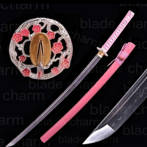 May include: A decorative katana sword with a pink handle and scabbard. The blade is silver, and the guard is silver with red floral accents. The sword is displayed against a black background.