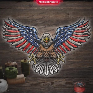 May include: Embroidered American bald eagle with outstretched wings, featuring the US flag design. The eagle's wings display red and white stripes with blue stars. The image is set against a dark wood grain background. The text "FREE SHIPPING" is in the top corner.