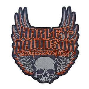 May include: Embroidered patch featuring the Harley-Davidson Motorcycles logo. The design includes a skull with wings, and the brand name in orange and black. The patch has a dark blue border and is suitable for jackets or bags.