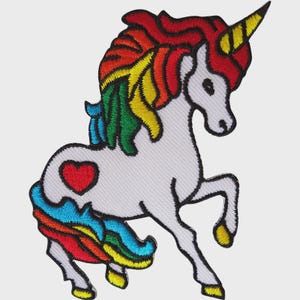 May include: Embroidered patch featuring a white unicorn with a rainbow mane and tail. The unicorn has a red heart on its side and a yellow horn. The patch is outlined in black.