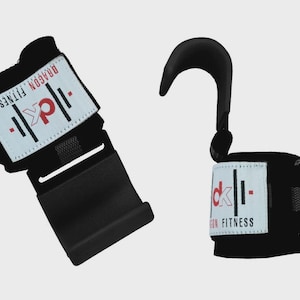 May include: Black weightlifting wrist straps with a hook design. Each strap features a white label with the text "DRAGON FITNESS" and a logo. The straps are designed to assist with weightlifting exercises.