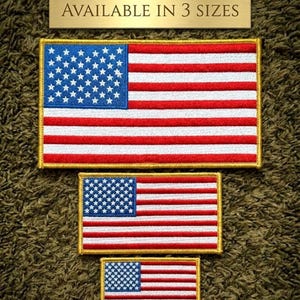 May include: Three embroidered American flag patches in varying sizes. The flags feature a blue field with white stars and red and white stripes. The patches have a gold border and the text "AVAILABLE IN 3 SIZES" is above them.