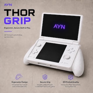 May include: White AYN Thor Grip with the text "THOR GRIP" in black and purple. The screen displays "AYN" in purple. The grip is designed for comfort and a secure hold. The text "Ergonomic. Secure. Built to Play." is also visible.