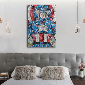 May include: A framed Captain America art print. The artwork features a collage of comic book images forming the iconic superhero. The color palette includes red, white, and blue, with a large star on the chest. The print is displayed above a bed.