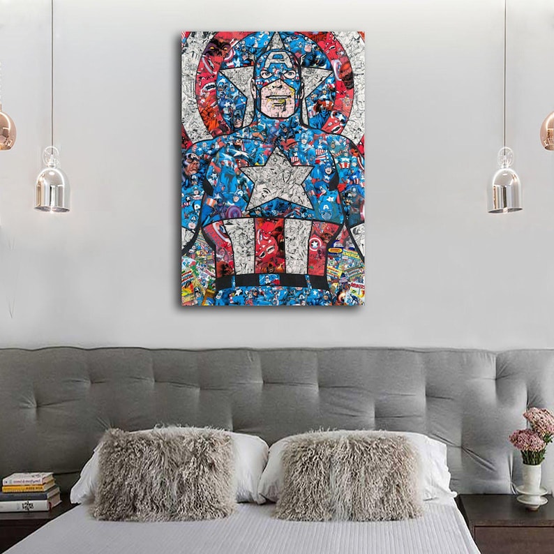 May include: A framed Captain America art print. The artwork features a collage of comic book images forming the iconic superhero. The color palette includes red, white, and blue, with a large star on the chest. The print is displayed above a bed.