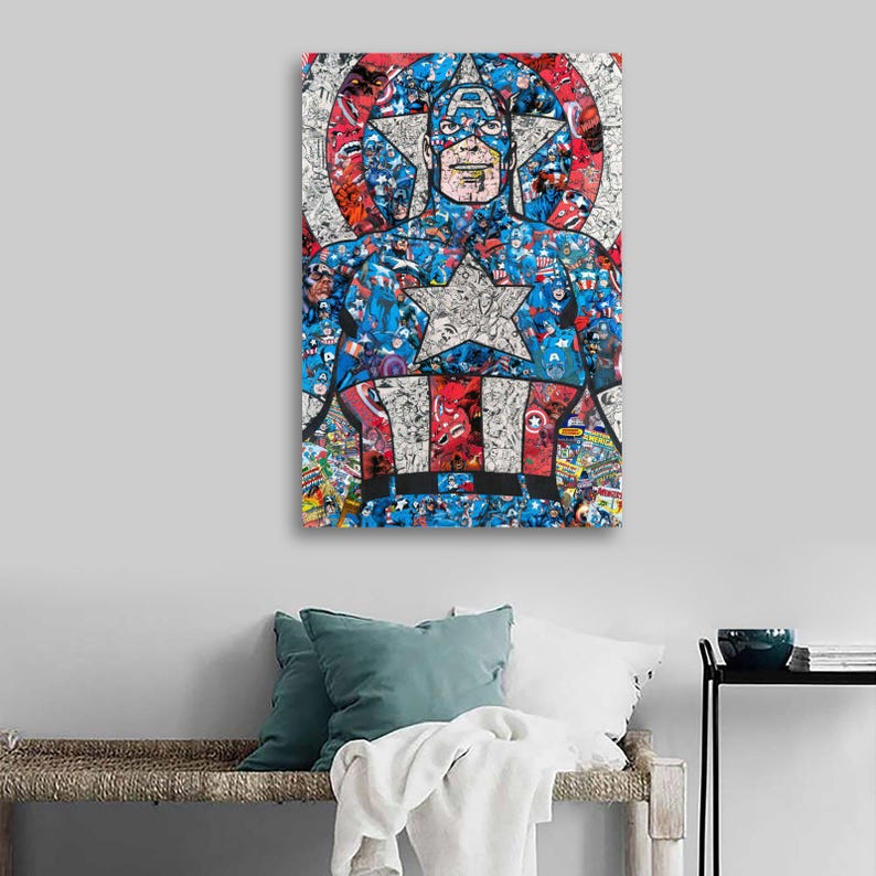 May include: A framed Captain America artwork. The artwork features a collage of Captain America images in a portrait style. The color palette includes red, white, blue, and black. The artwork is displayed on a light gray wall above a bench with pillows.