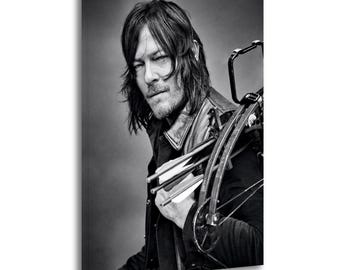 May include: Black and white portrait of a person holding a crossbow and arrows. The person is wearing a black leather jacket and has long, dark hair. The image is a close-up shot, with the person looking directly at the viewer.