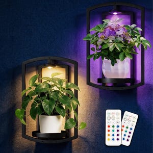 May include: Two black metal wall-mounted plant shelves with integrated LED lights. One shelf holds a green plant in a white pot with warm yellow lighting, while the other holds a plant in a white pot with purple lighting. Two remote controls are included.