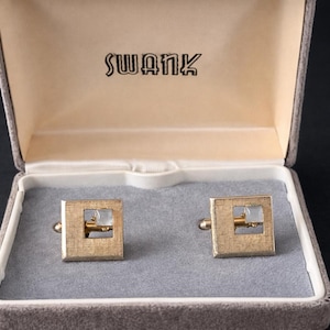 May include: A set of three ceramic mugs with a speckled, matte finish in cream, light grey, and dark grey. Each mug has a simple, minimalist design and a rounded handle.