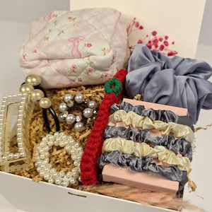 May include: A set of three ceramic mugs with a speckled, matte finish. The mugs are in shades of cream, light gray, and dark gray. Each mug has a simple, modern design and a rounded handle. Perfect for coffee or tea.