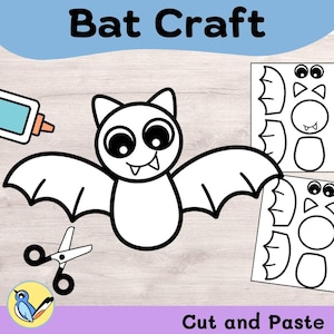 May include: A Bat Craft cut and paste activity sheet featuring a black and white line drawing of a bat with large eyes and fangs. The image includes a glue bottle, scissors, and two printed templates showing bat wings, ears, and body shapes.