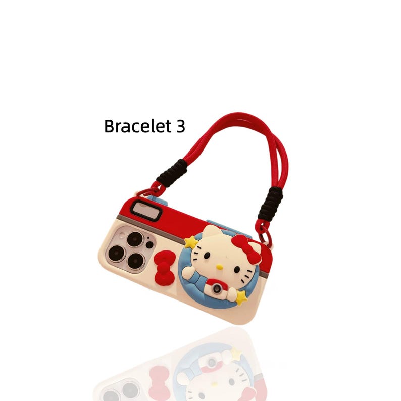 May include: A white, red, and black phone case with a cartoon character design. The case has a red strap and the text "Bracelet 3". The design features a cartoon character with a red bow and a camera.