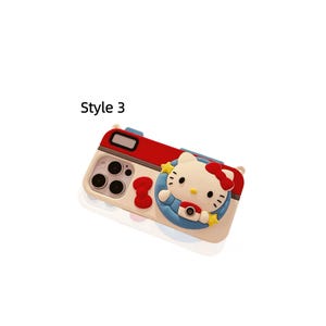 May include: A phone case with a red and white camera design. The case features a cartoon character with a red bow, blue outfit, and yellow stars. The text "Style 3" is printed on the case.