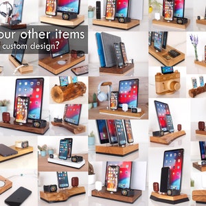 May include: A selection of wooden charging stations and organisers for smartphones, tablets, and smartwatches. The image shows various designs, including stands with integrated charging pads and holders. Text on the image reads: "See our other items. Need a custom design?"