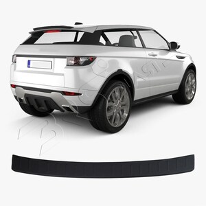 May include: A white SUV with black accents, featuring a rear view. The vehicle has silver wheels and a black bumper protector. The bumper protector is a curved, rectangular shape with a textured surface.