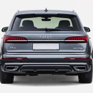May include: Rear view of a gray Audi Q7 SUV. Features include red taillights, a chrome trim, and dual exhaust pipes. The license plate area is blank. The model designation "Q7" and "50 TDI" are visible.