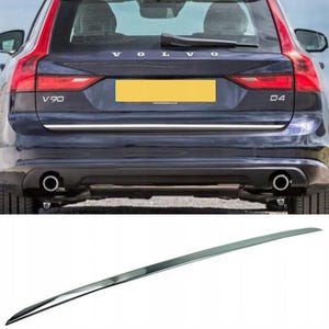 Può includere: Una finitura cromata per una Volvo V90. L'immagine mostra la parte posteriore di una Volvo V90 blu scuro con la finitura sotto il bagagliaio. L'auto ha il testo "V90" e "D4" sul retro.