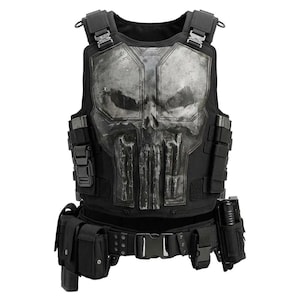 May include: A black tactical vest featuring a large, weathered, metallic-look skull emblem on the chest. The vest includes adjustable shoulder straps with buckles, side webbing, and a utility belt equipped with multiple pouches and holsters.
