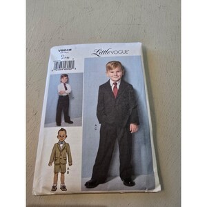 May include: A sewing pattern for a Little Vogue suit. The pattern features illustrations of a boy in a suit with a tie, and another in a suit with shorts. The pattern number is V9248.
