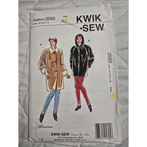 May include: A sewing pattern titled "Pattern 2560" by Kwik Sew. The pattern features illustrations of two coats, with sizes XS-XL. The pattern's cover is white with black and brown text and illustrations.