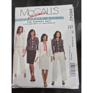 May include: McCall's sewing pattern for a classic fit suit, featuring various suit styles. The pattern includes options for jackets, skirts, and pants. The size range is FF (16-18-20-22). The text on the pattern reads "The Perfect Suit".
