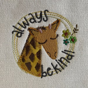 May include: Embroidered design on a beige fabric featuring a giraffe with closed eyes and the words "always be kind" in a circle.