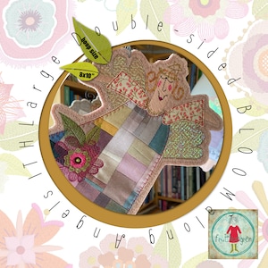 May include: Double-sided embroidery design of an angel with a patchwork quilt pattern. The design is for a large hoop size of 8x10 inches. The design is from Fruit & Wren.