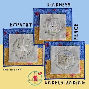 May include: Three embroidered squares with different quotes about peace, empathy, and kindness. Each square is framed with a blue and yellow patterned fabric. The squares are labeled "Peace", "Empathy", and "Kindness".