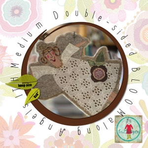 May include: Double-sided embroidery pattern for a medium hoop, 8x8 inches, featuring a whimsical angel with a flower and the text "Double-sided Bloom Angels".