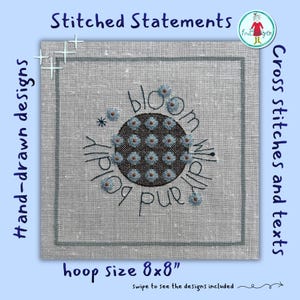 May include: A square piece of light gray linen fabric featuring a central dark brown circular cross-stitch pattern filled with small light blue flowers. The text "bloom wildly and boldly" is stitched in black thread around the circle. The hoop size is 8x8 inches.