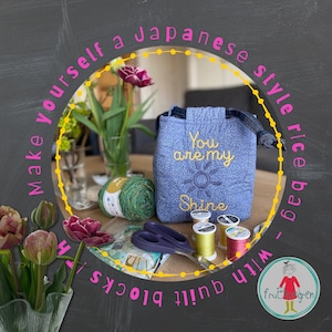 Pode incluir: Uma bolsa de arroz de tecido azul com o texto "You are my Shine" bordado nela. A bolsa é cercada por fio, tesoura e carretéis de fio.