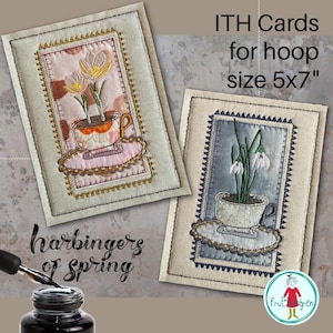 May include: Two embroidered cards with floral designs. One card features a teacup with flowers, the other has snowdrops. The cards are labeled "ITH Cards for hoop size 12.7x17.8cm" and "harbingers of spring."