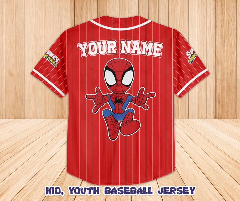 May include: Red and white baseball jersey with a cartoon Spider-Man graphic. The jersey has vertical white stripes and the text "YOUR NAME" across the back. The bottom of the jersey reads "KID, YOUTH BASEBALL JERSEY".