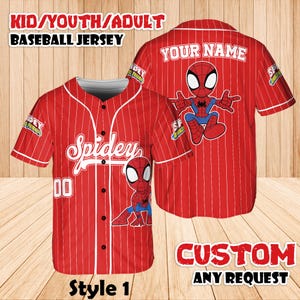 May include: Red baseball jersey with white pinstripes, featuring a cartoon Spider-Man graphic. The front says "Spidey" and "00". The back has "YOUR NAME" above a Spider-Man graphic. Text at the top says "KID/YOUTH/ADULT BASEBALL JERSEY".