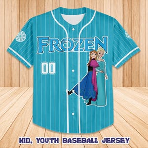 May include: A turquoise baseball jersey with white pinstripes, featuring the word "FROZEN" in blue, the number "00", and images of two characters. The jersey has white accents and the text "KID, YOUTH BASEBALL JERSEY" at the bottom.