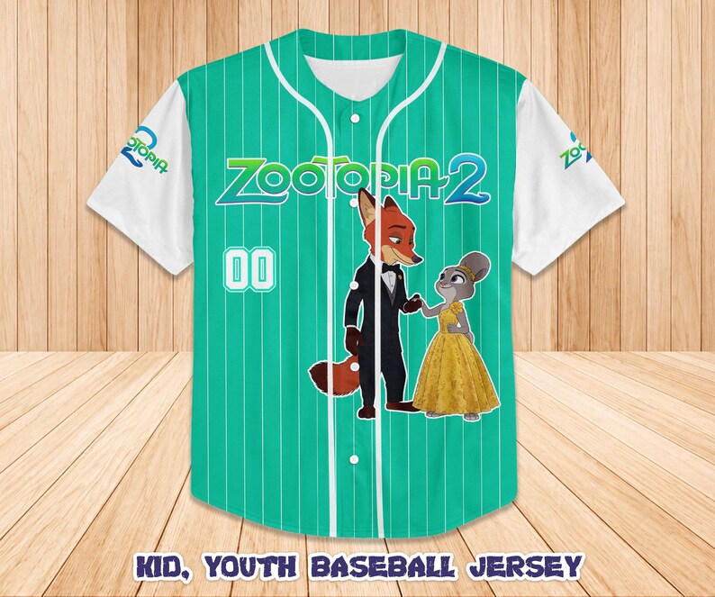 May include: A green and white baseball jersey featuring the characters Nick Wilde and Judy Hopps from Zootopia 2. The jersey has vertical stripes, the number 00, and the text "Zootopia 2". The sleeves are white.