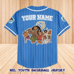 May include: Blue baseball jersey with white pinstripes and white trim. The back features a graphic of animated characters and the text "YOUR NAME". The jersey also has the text "KID, YOUTH BASEBALL JERSEY".