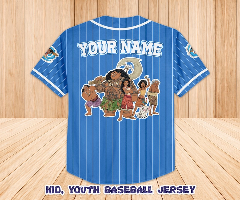 May include: Blue baseball jersey with white pinstripes and white trim. The back features a graphic of animated characters and the text "YOUR NAME". The jersey also has the text "KID, YOUTH BASEBALL JERSEY".