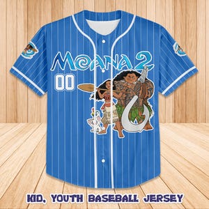 May include: Blue baseball jersey with white pinstripes, featuring the text "Moana 2" and the number "00". The jersey has a graphic of Moana, Maui, and Pua. The text "KID, YOUTH BASEBALL JERSEY" is at the bottom.