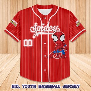 May include: Red baseball jersey with white pinstripes, featuring the word "Spidey" in white script and a cartoon Spider-Man graphic. The number "00" is on the front. The sleeves have patches. The text "KID, YOUTH BASEBALL JERSEY" is at the bottom.