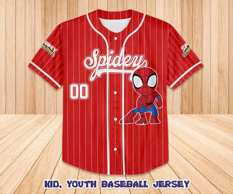 May include: Red baseball jersey with white pinstripes, featuring the word "Spidey" in white script and a cartoon Spider-Man graphic. The number "00" is on the front. The sleeves have patches. The text "KID, YOUTH BASEBALL JERSEY" is at the bottom.