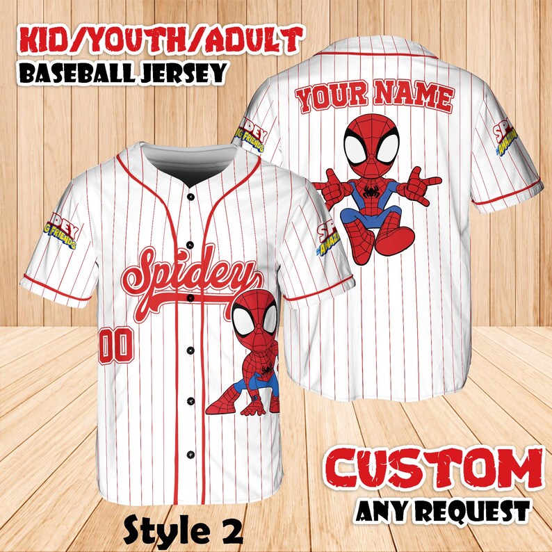 May include: White baseball jersey with red pinstripes and a cartoon Spider-Man graphic. The jersey has the word "Spidey" in red script on the front, with the number "00" below. The text "KID/YOUTH/ADULT BASEBALL JERSEY" is at the top.