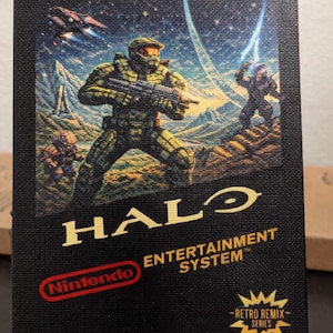 May include: Black Nintendo Entertainment System game cartridge featuring the Halo video game. The artwork depicts a futuristic battle scene with soldiers and a spaceship. The text "HALO" and "ENTERTAINMENT SYSTEM" are visible.