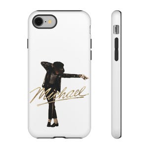 May include: White phone case with a gold script of the name "Michael" and an image of a person in a black suit and hat. The person is in a dance pose. The phone case has black side buttons and a camera cutout.